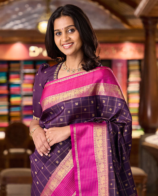 Eggplant purple annam chakram buttas enclosed checked Kanchipuram silksaree, contrast border of thilakm mokku, laddu kamalam, and mayil designs, and intricate pallu