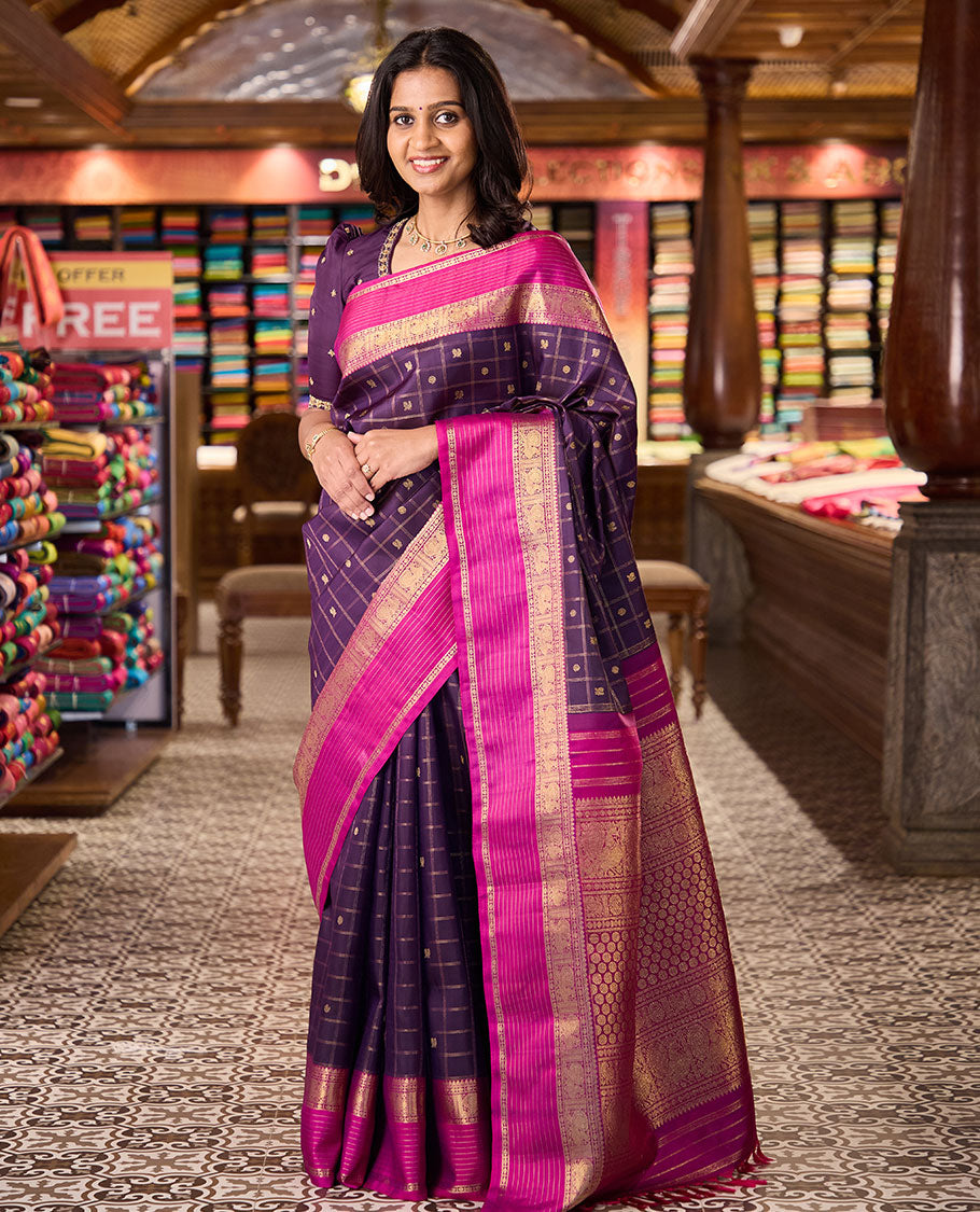 Eggplant purple annam chakram buttas enclosed checked Kanchipuram silksaree, contrast border of thilakm mokku, laddu kamalam, and mayil designs, and intricate pallu