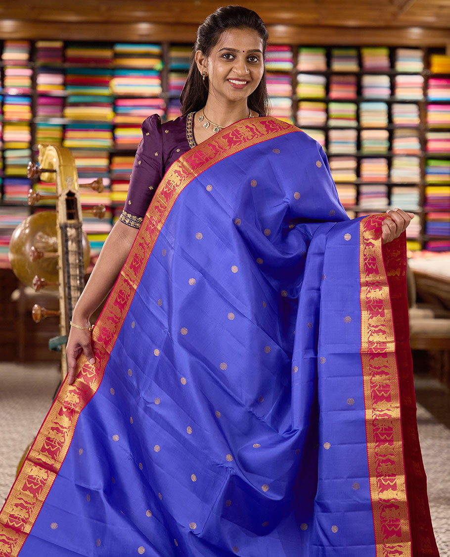 Royal blue chakram buttas Kanchipuram silk saree, contrast border of thilakam mokku,kathir, and Mythological characters, and pallu of Mythological motifs