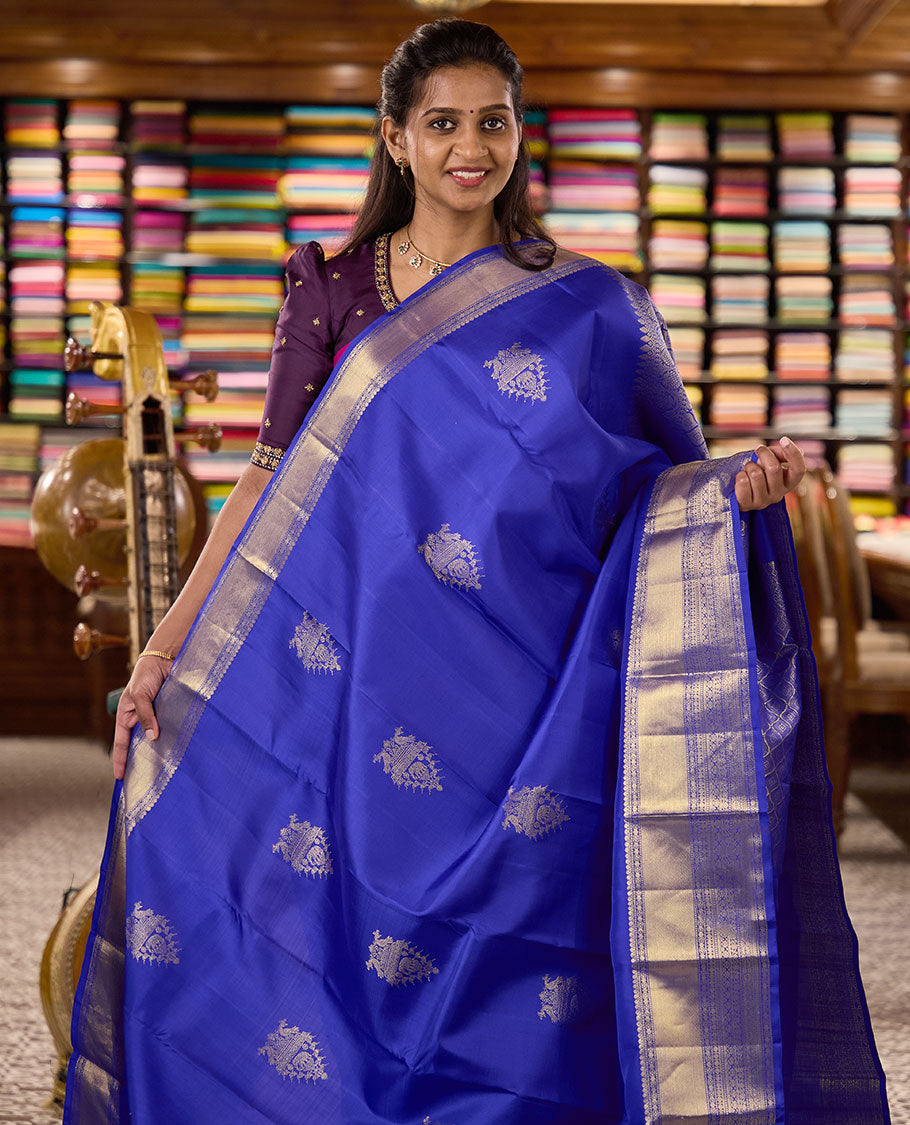 Royal blue zari buttas woven Kanchipuram silk saree, zari border of thilakam mokku, muthu, rudraksham, kodi visiry, chakram, and kathir designs, and jaal pallu