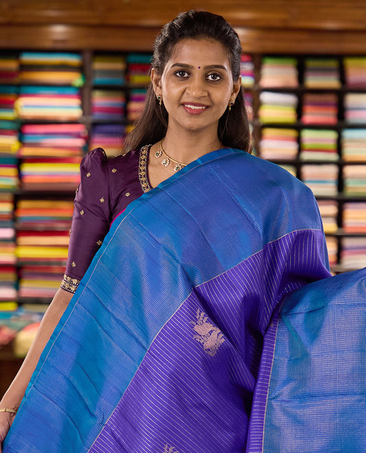 Blue zari buttas and striped kanchipuram silk saree, contrast zari vaira-oosai checked border, and zari design pallu