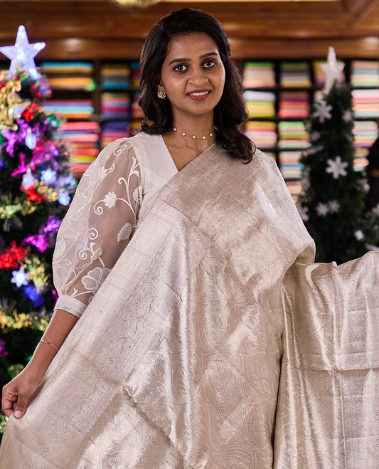 Pearl white Mughal-style ogee jacquard silk saree, traditional zari motifs sparsely woven border, and pallu