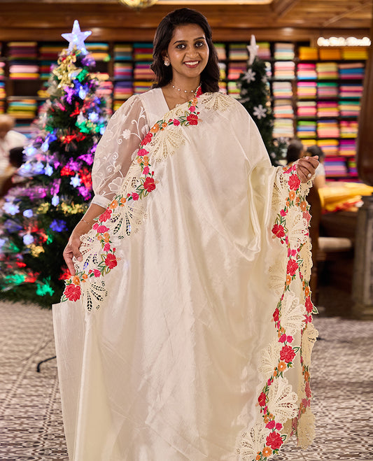 Creamy white plain matka silk saree, scallop realistic multi-color floral motifs thread and cut embroidered border