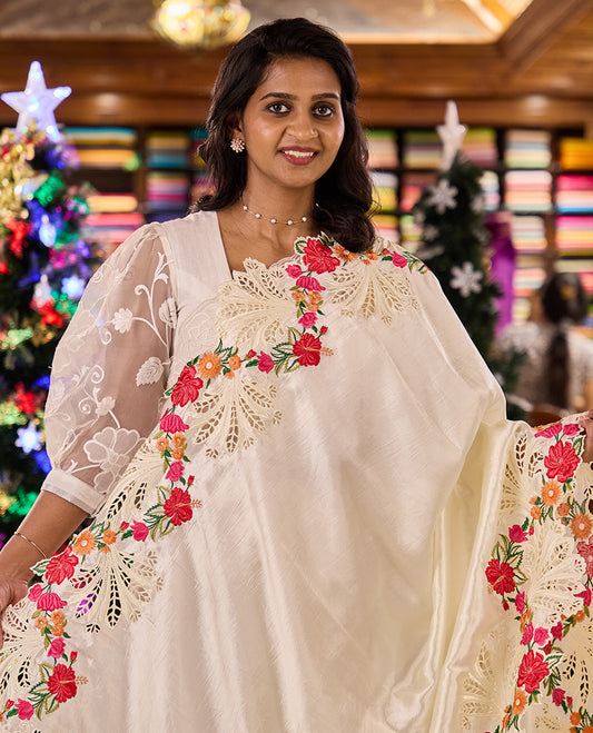 Creamy white plain matka silk saree, scallop realistic multi-color floral motifs thread and cut embroidered border
