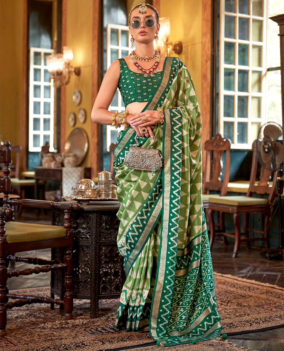 Green triangle buttas patola designer catalog saree, contrast ikkat geometric border and pallu of ikkat jaal design