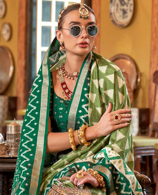 Green triangle buttas patola designer catalog saree, contrast ikkat geometric border and pallu of ikkat jaal design