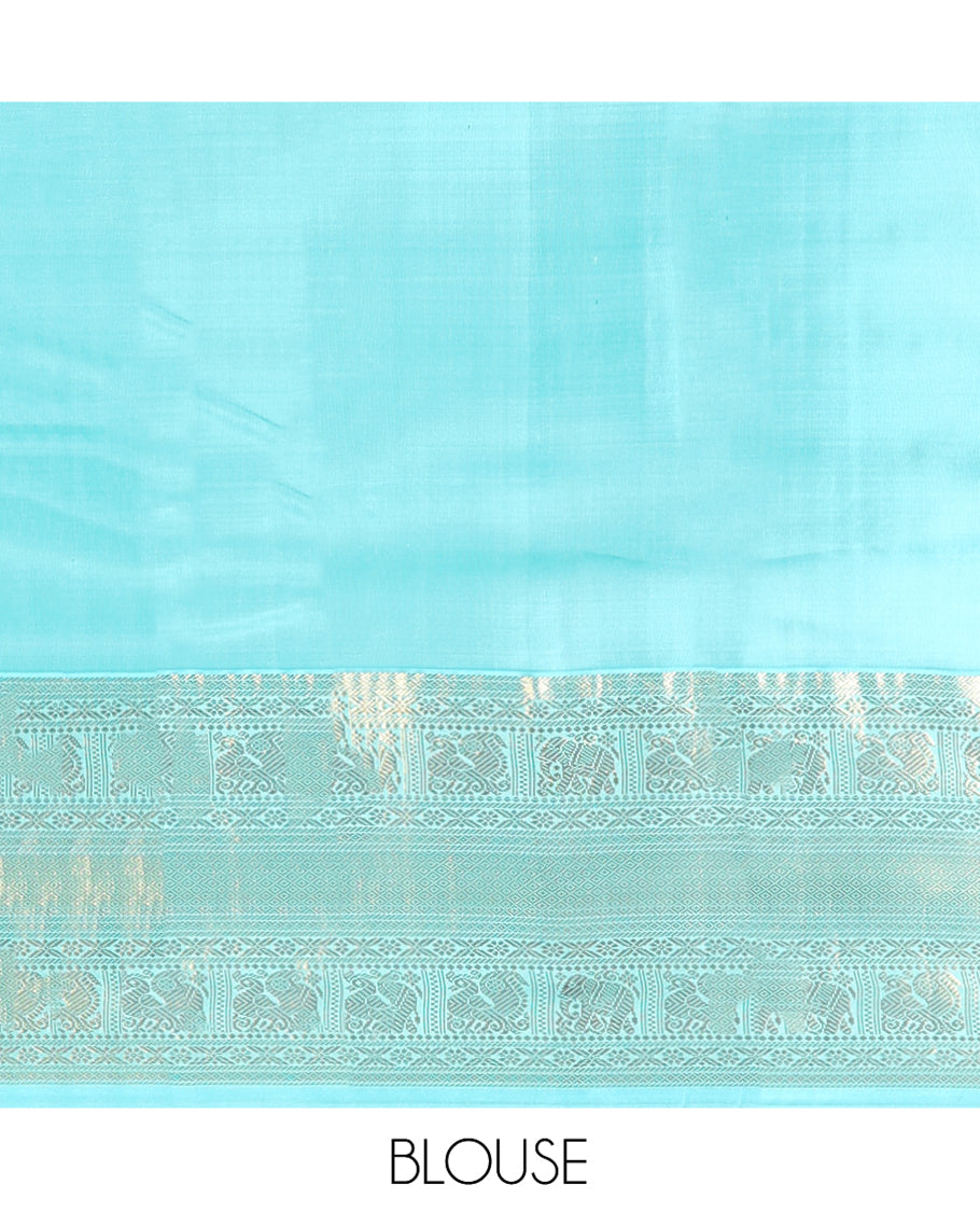Brown Vasundhara Silk Saree Delicately Woven with Zari Buttas, Highlighted with a Contrast Border of Cross Kamalam, Mayil, Banaras, Yaanai, and Mayil Kann Designs, Pallu Grandly Woven with Jaal Designs, and Paired with a Contrast Blouse