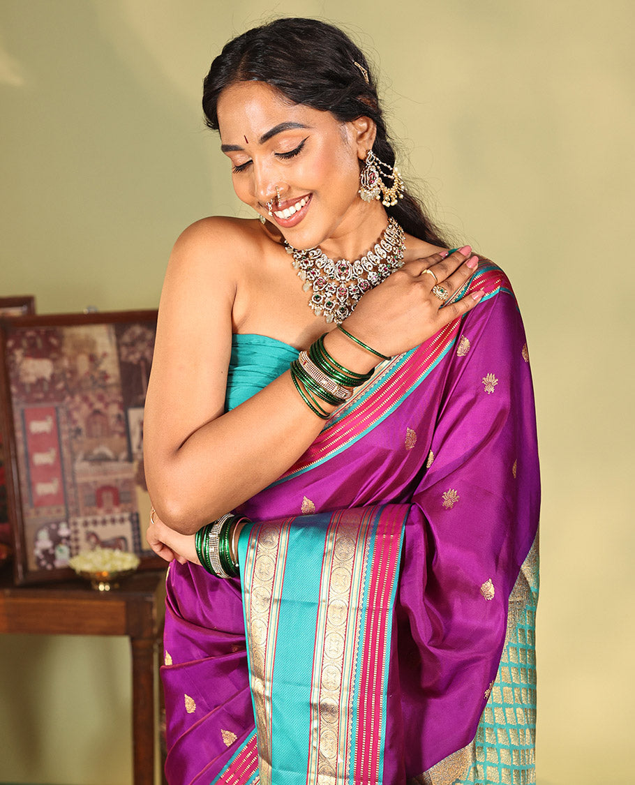 Purple Vasundhara Silk Saree, Beautifully Bedecked with Kamalam Buttas on Its Body, Complemented by a Captivating Contrast Border of Muthu, Chakram, and Mayil Kann Designs, Grand Jaal Pallu, and Paired with a Contrast Blouse
