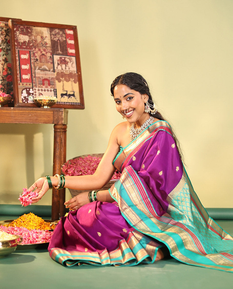 Purple Vasundhara Silk Saree, Beautifully Bedecked with Kamalam Buttas on Its Body, Complemented by a Captivating Contrast Border of Muthu, Chakram, and Mayil Kann Designs, Grand Jaal Pallu, and Paired with a Contrast Blouse