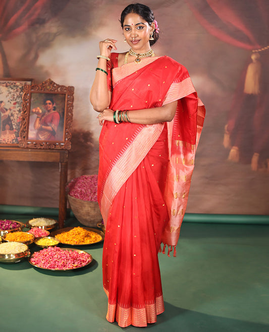 Red Vasundhara Silk Saree, Gracefully Woven with Kamalam Buttas on Its Body, Complemented by a Captivating Contrast Thazampoo Rekku Border of Banaras Designs, Zari-Decked Up Pallu, and Paired with a Contrast Blouse