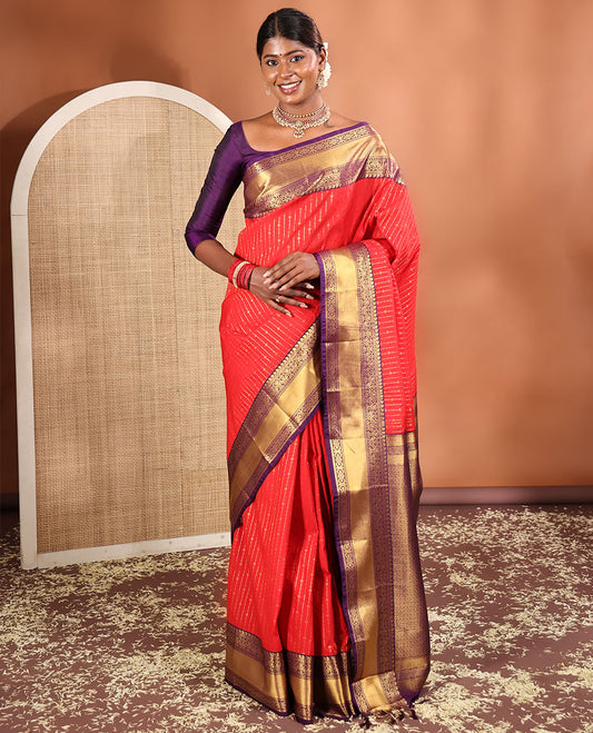 Red Budget Silk Saree, Embellished with Zari Stripes All Across Its Body, Complemented by Captivating Contrast Traditional Zari Designs Woven Border, Grandly Decked Up Jaal Patterned Pallu, and Paired with a Contrast Blouse