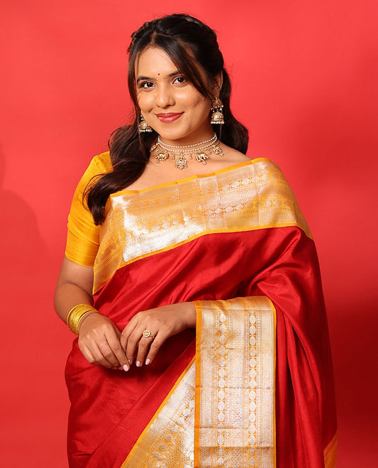 Red plain Kanchipuram silk saree, contrast korvai border of muthu, vanki, neli, rudraksham, and mayil kann, and traditional zari steeped pallu