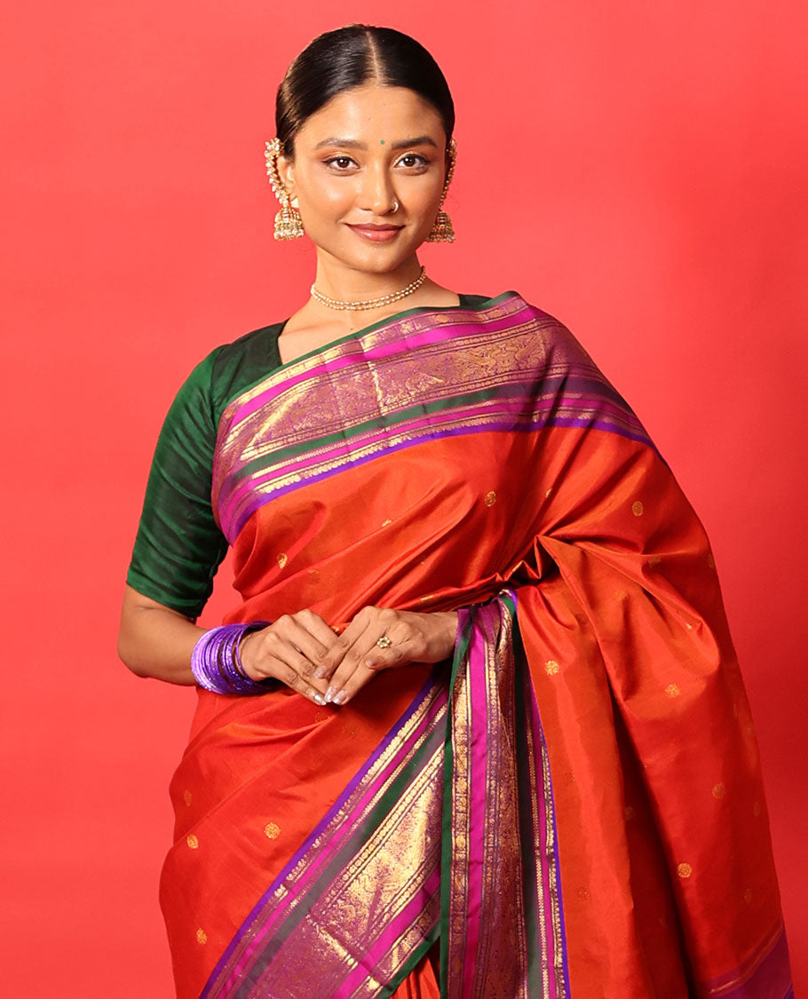 Orange zari buttas Kanchipuram silk saree, contrast border of manga mokku, banaras, kamalam, manga, rekku, mayil, and poun designs geometric patterned pallu