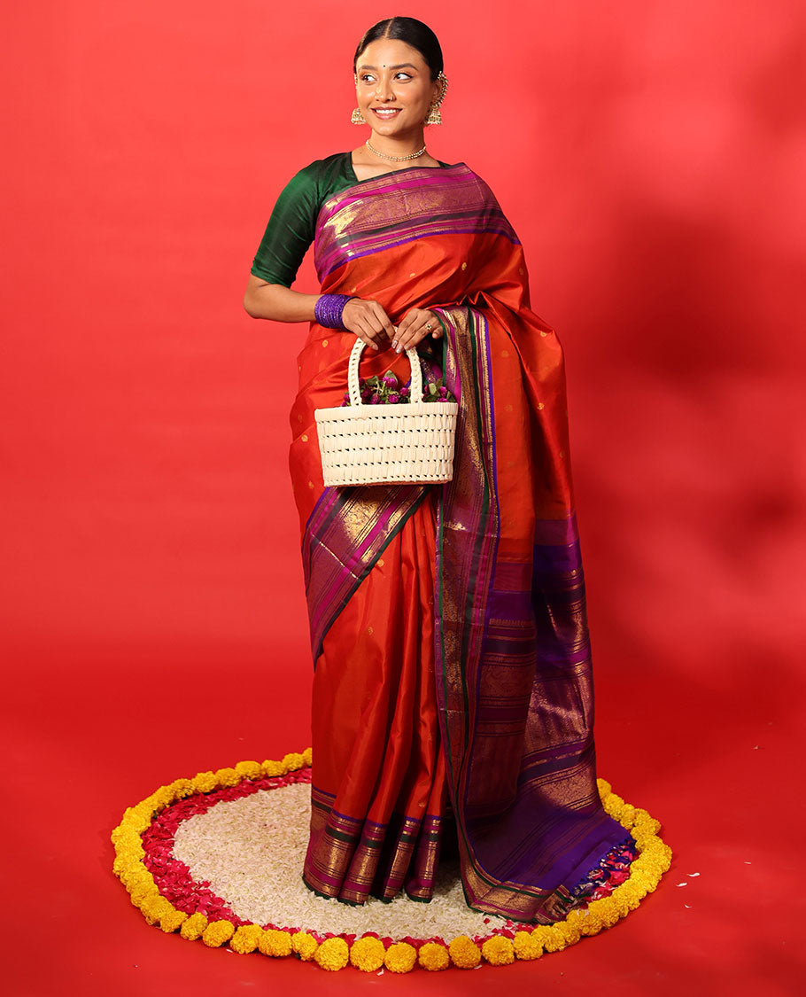 Orange zari buttas Kanchipuram silk saree, contrast border of manga mokku, banaras, kamalam, manga, rekku, mayil, and poun designs geometric patterned pallu