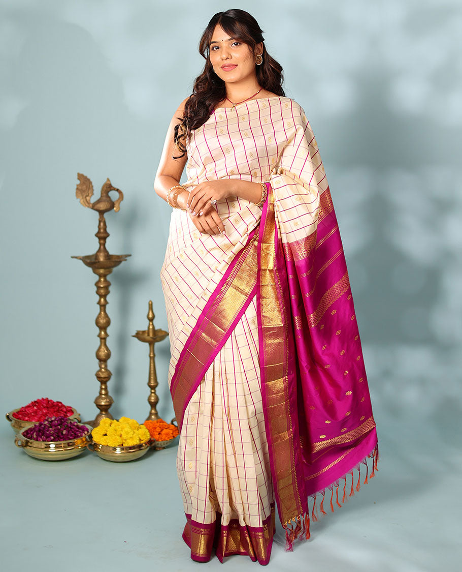 Cream kamalam zari buttas with checked Kanchipuram silk saree, contrast korvai border of thilakam mokku, banaras, and mayil kann designs, and zari design pallu