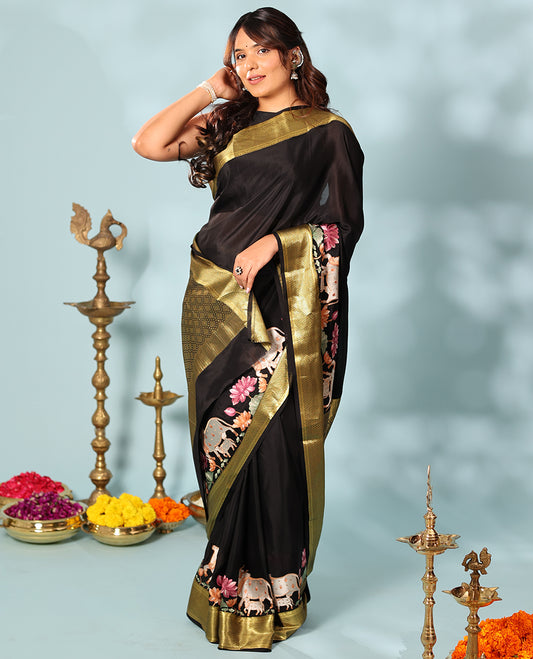 Black delicately thread hand embroidered Mysore silk saree features Pichwai lotus vine, and cow motifs, traditional zari border, and jaal pallu