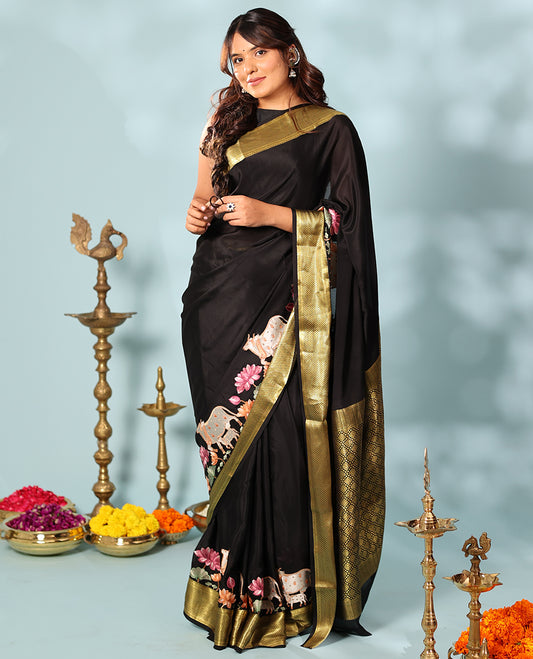 Black delicately thread hand embroidered Mysore silk saree features Pichwai lotus vine, and cow motifs, traditional zari border, and jaal pallu