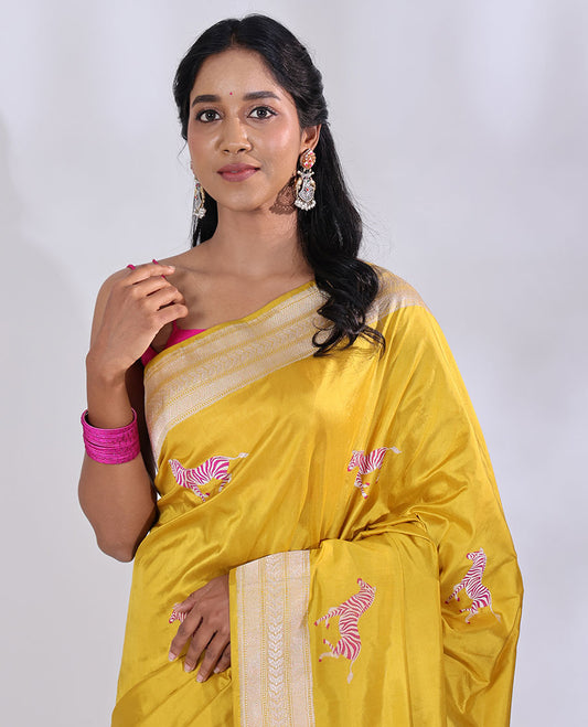 Yellow Banarasi Silk Saree Elevated with Zebra Motifs All Over Its Body, a Subtle Border of Traditional Designs, Pallu Decked Up with Floral and Diamond Designs, and Paired with a Matching Blouse