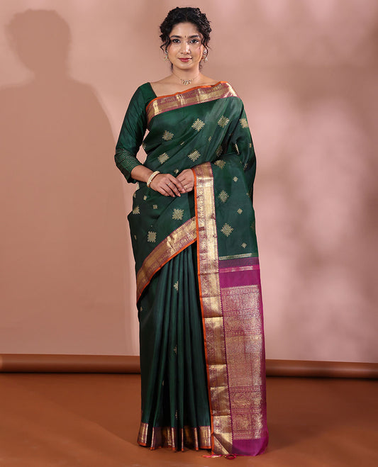 Green Kanchipuram Soft Silk Saree Artfully Detailed with Kolam Buttas, Complemented by a Contrast Border of Thilakam Mokku, Muthu, Yaanai, and Mayil Designs, Zari-Rich Pallu of Mayil Kann Designs, and Paired with a Contrast Blouse