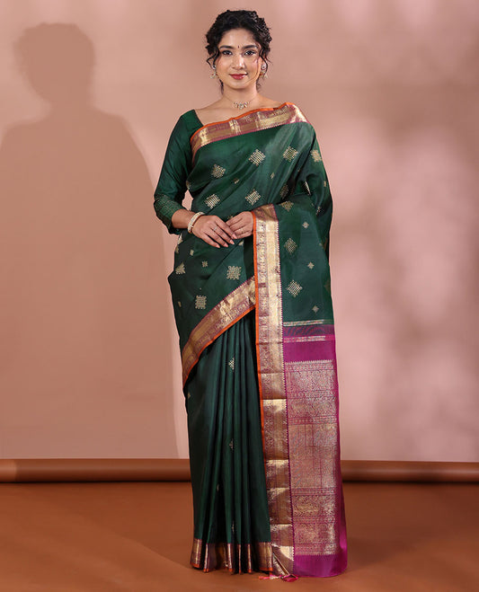 Green Kanchipuram Soft Silk Saree Artfully Detailed with Kolam Buttas, Complemented by a Contrast Border of Thilakam Mokku, Muthu, Yaanai, and Mayil Designs, Zari-Rich Pallu of Mayil Kann Designs, and Paired with a Contrast Blouse