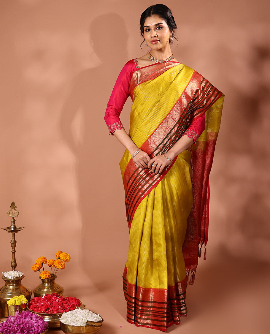 Yellow Muthu striped silk saree, contrast border of thilakam mokku, Muthu, banaras, mayil, kamalam, and neli designs, and intricate pallu