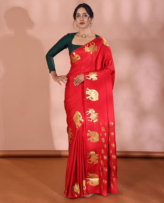 Red Plain Mysore Silk Saree, Elegantly Highlighted Border of Elephant and Horse Zari Buttas, Pallu Steeped with Miniature Elephant and Horse Motifs in Zari, and Paired with a Matching Blouse