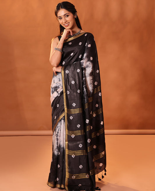 Black and Cream Banana Pith Saree Elevated with Shibori Tie-Dye Print All Over Its Body, Subtle Piping Zari Border, Pallu Depicts Shibori Motifs Print, and Paired with a Matching Blouse