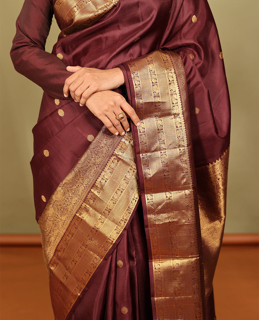 Brown Kanchipuram Silk Saree, Adorned with Zari Buttas, a Zari Border of Iruthalai Pakshi, Thilakam, Kathir, Mayil, Yaanai, and Mayil Kann Designs, Jaal Pallu, and a Matching Blouse