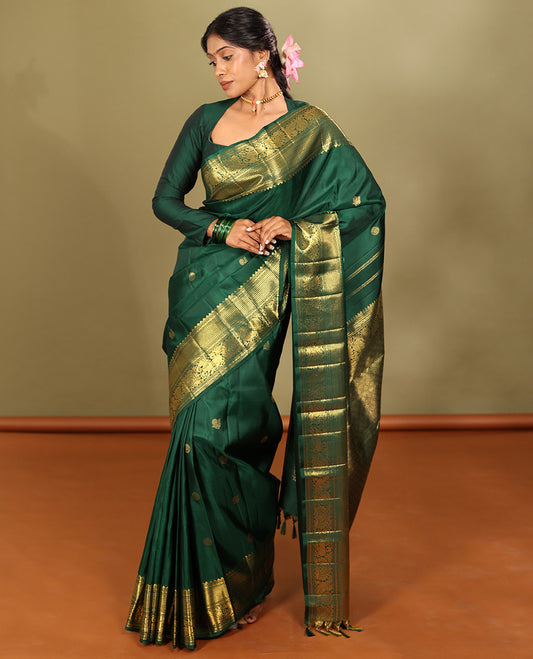 Green Kanchipuram Silk Saree, Elevated with Mayil-Chakram Buttas, a Zari Border of Rekku, Muthu, Mayil Kann, Banaras, Mayil, and Yaali Designs, Jaal Pallu, and a Matching Blouse