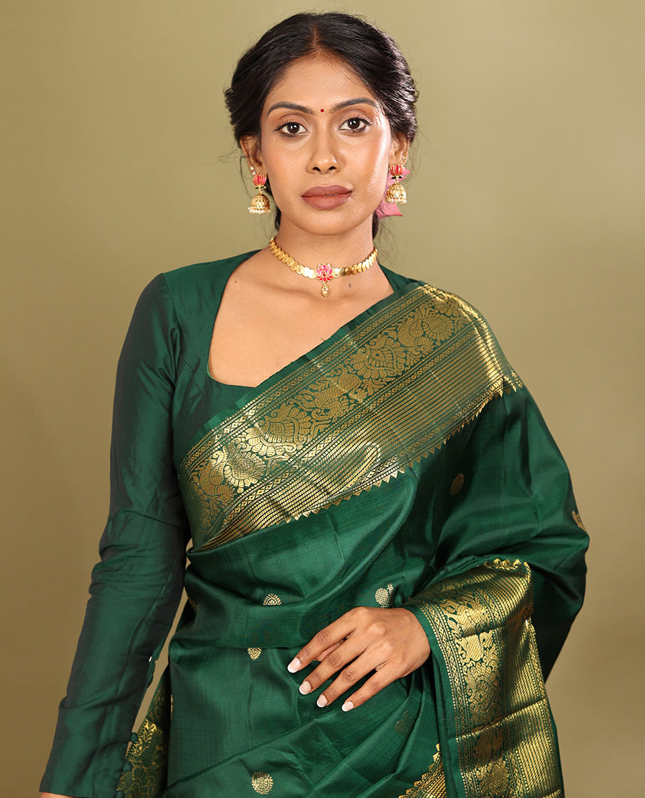 Green Kanchipuram Silk Saree, Elevated with Mayil-Chakram Buttas, a Zari Border of Rekku, Muthu, Mayil Kann, Banaras, Mayil, and Yaali Designs, Jaal Pallu, and a Matching Blouse