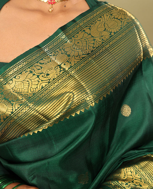 Green Kanchipuram Silk Saree, Elevated with Mayil-Chakram Buttas, a Zari Border of Rekku, Muthu, Mayil Kann, Banaras, Mayil, and Yaali Designs, Jaal Pallu, and a Matching Blouse