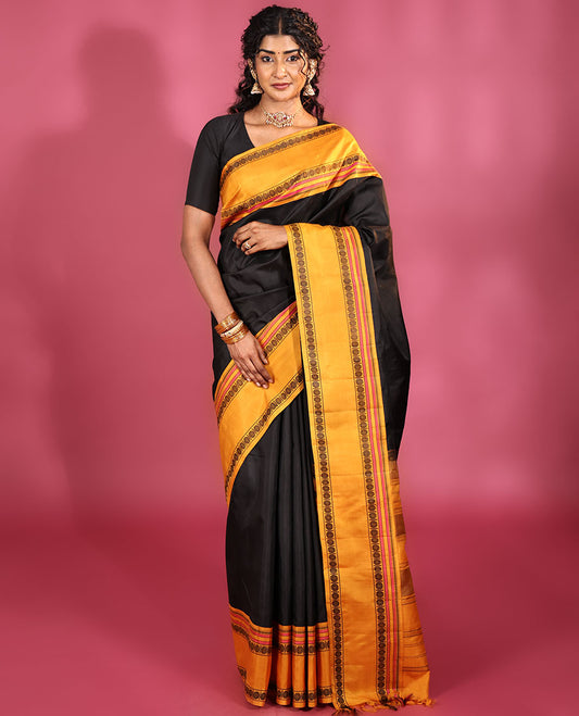 Black Plain Kanchipuram Silk Saree, Complemented by Captivating Contrast Rettai Pettu Border of Rekku, Muthu, and Rudraksham Designs, a Subtle Pallu of Thread Weave, and Paired with a Contrast Blouse