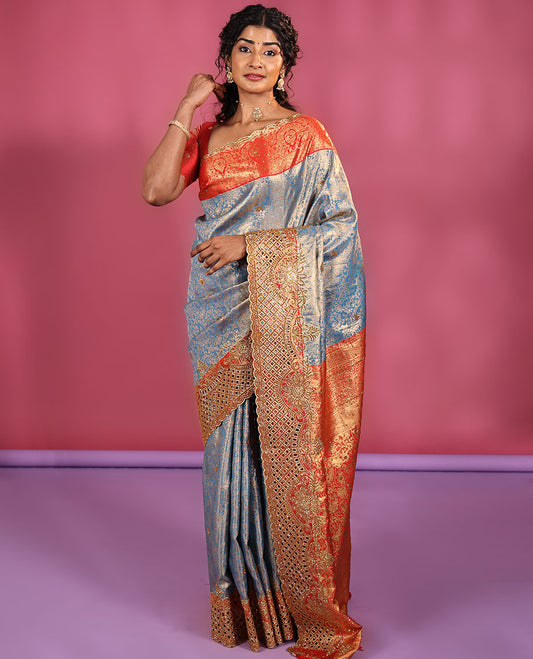 Blue Vastrakala Silk Saree, Adorned with Floral Jacquard and Stone Work, Complemented by Contrast Traditional Zari and Cut Embroidered Scallop Border, Gleaming Grand Zari-Stone Work Pallu, and Paired with Contrast Heavy Stone Embroidered Blouse
