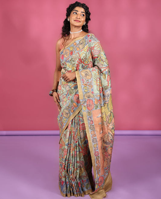 Light Pista Semi-Tussar Saree Colorfully Highlighted with Kalamkari-Style Floral Vine Print, Captivating Contrast Border Printed with Floral Motifs, Pallu Depicting Krishna and Gopis Print, and Paired with a Contrast Printed Blouse