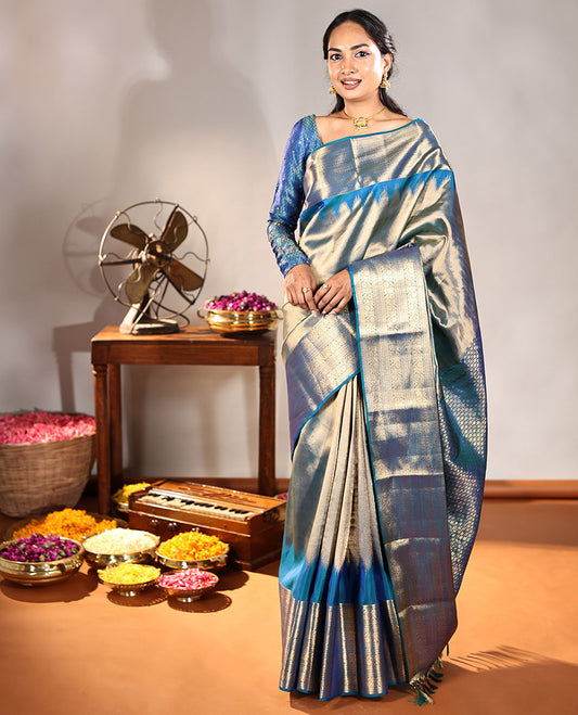 Scintillating Blue Vasundhara Lite-Silk Mix Saree, Gleamed Up with Zari on Its Body, Highlighted by Thazampoo Rekku Border of Neli, Paisa, Cross Kamalam, and Kodi Visiry Designs, a Grand Geometric-Patterned Pallu, and Paired with a Matching Blouse
