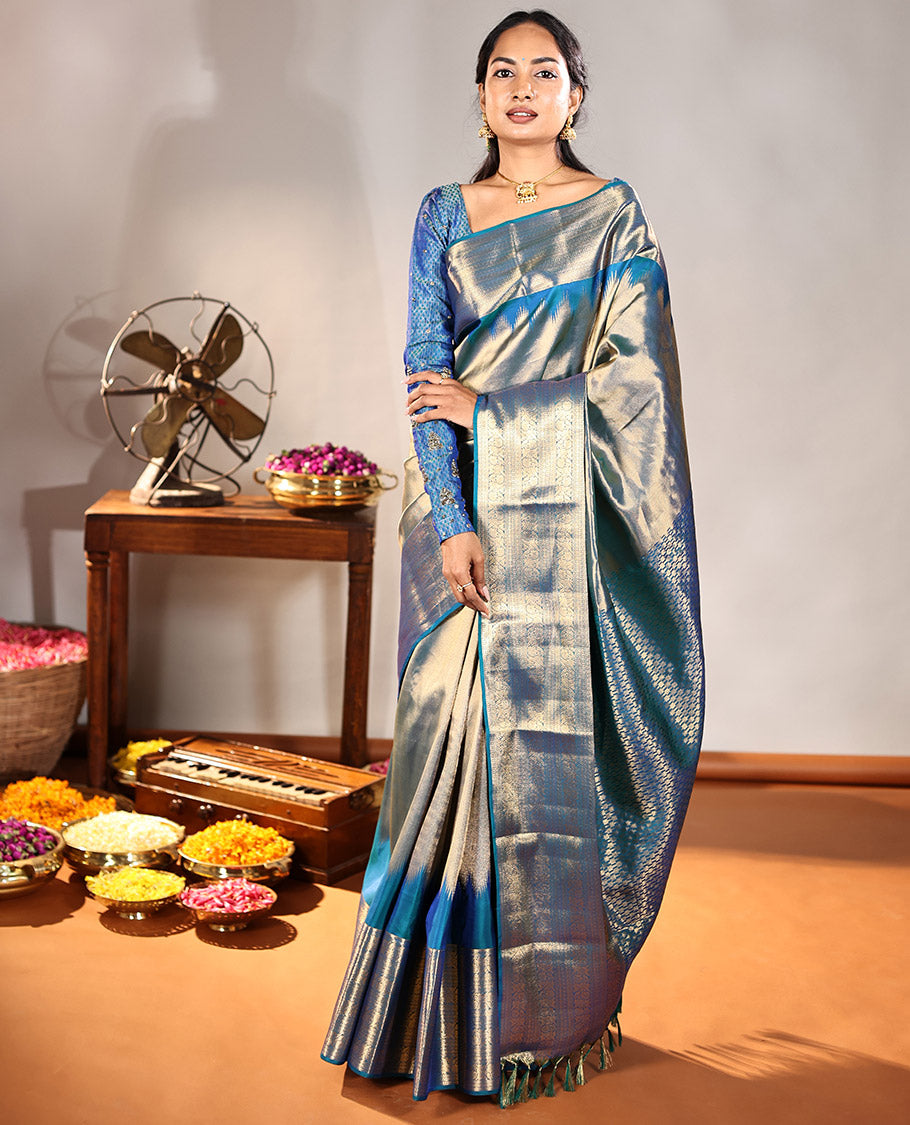 Scintillating Blue Vasundhara Lite-Silk Mix Saree, Gleamed Up with Zari on Its Body, Highlighted by Thazampoo Rekku Border of Neli, Paisa, Cross Kamalam, and Kodi Visiry Designs, a Grand Geometric-Patterned Pallu, and Paired with a Matching Blouse