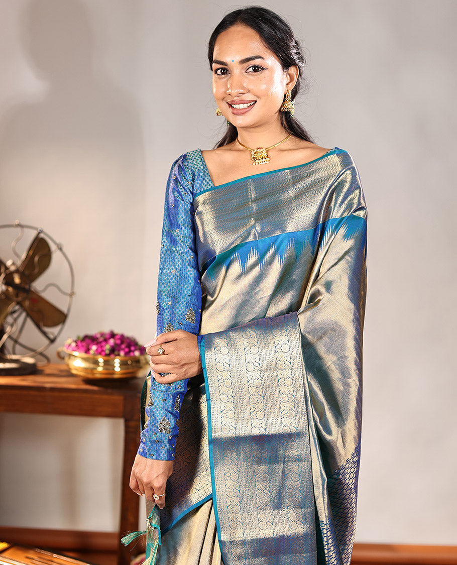 Scintillating Blue Vasundhara Lite-Silk Mix Saree, Gleamed Up with Zari on Its Body, Highlighted by Thazampoo Rekku Border of Neli, Paisa, Cross Kamalam, and Kodi Visiry Designs, a Grand Geometric-Patterned Pallu, and Paired with a Matching Blouse