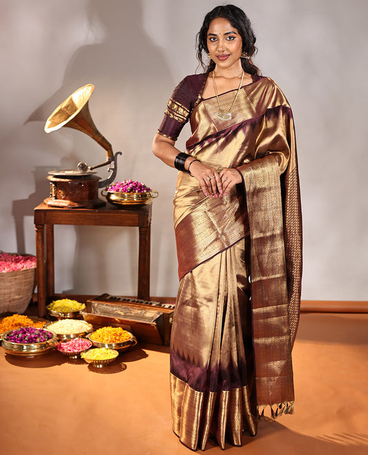 Scintillating Brown Vasundhara Lite-Silk Mix Saree, Gleamed Up with Zari on Its Body, Highlighted by Thazampoo Rekku Border of Neli, Paisa, Cross Kamalam, and Kodi Visiry Designs, a Grand Geometric-Patterned Pallu, and Paired with a Matching Blouse