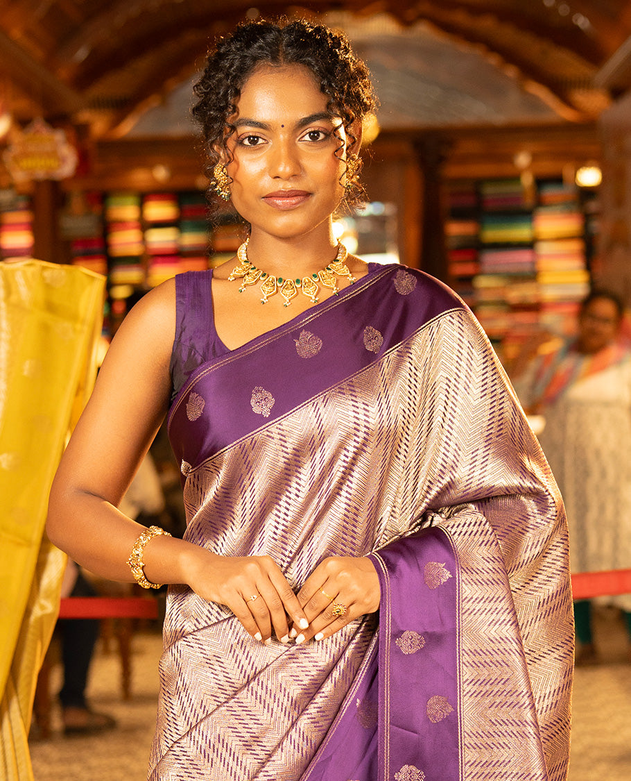 Purple Russian Dola Silk Saree, Meticulously Crafted with Zari Zig-Zag Jacquard on Its Body, Highlighted by Zari Buttas Woven Satin Border, Intricately Designed Pallu, and Paired with a Matching Blouse