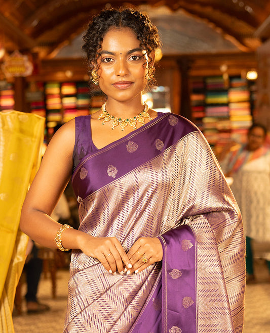 Purple Russian Dola Silk Saree, Meticulously Crafted with Zari Zig-Zag Jacquard on Its Body, Highlighted by Zari Buttas Woven Satin Border, Intricately Designed Pallu, and Paired with a Matching Blouse