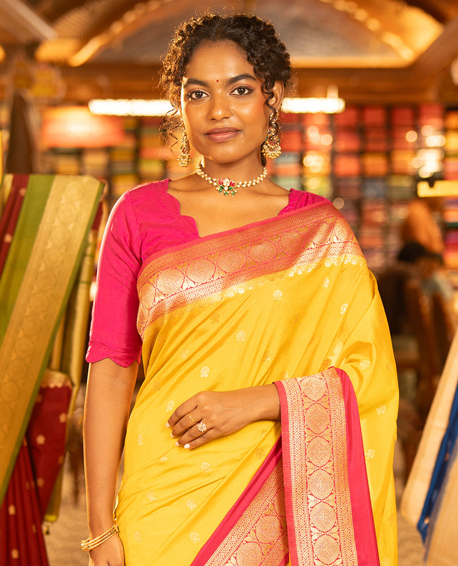 Mustard Yellow Dupion Silk Saree, Embellished with Buttas All Over Its Body, Complemented by Contrast Traditional Border of Paisleys and Chakram Designs, Intricately Designed Pallu, and Paired with a Contrast Blouse