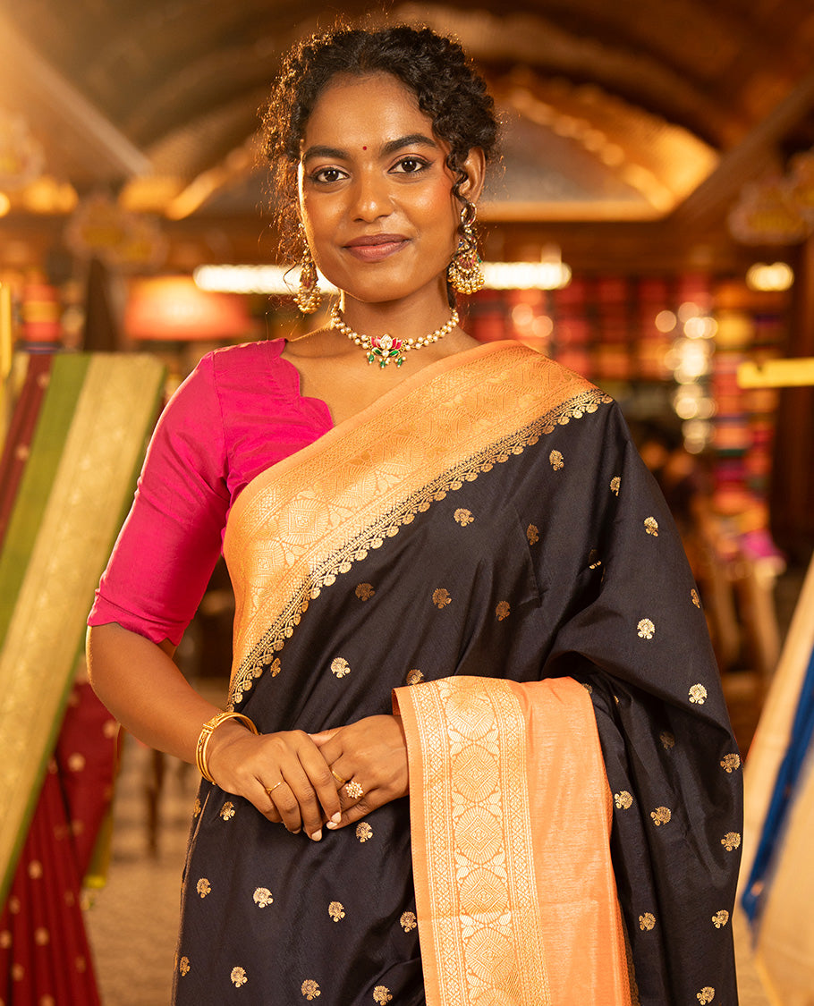 Navy Blue Dupion Silk Saree, Adorned with Buttas All Over Its Body, Complemented by Contrast Traditional Border of Paisleys and Chakram Designs, Intricately Designed Pallu, and Paired with a Contrast Blouse