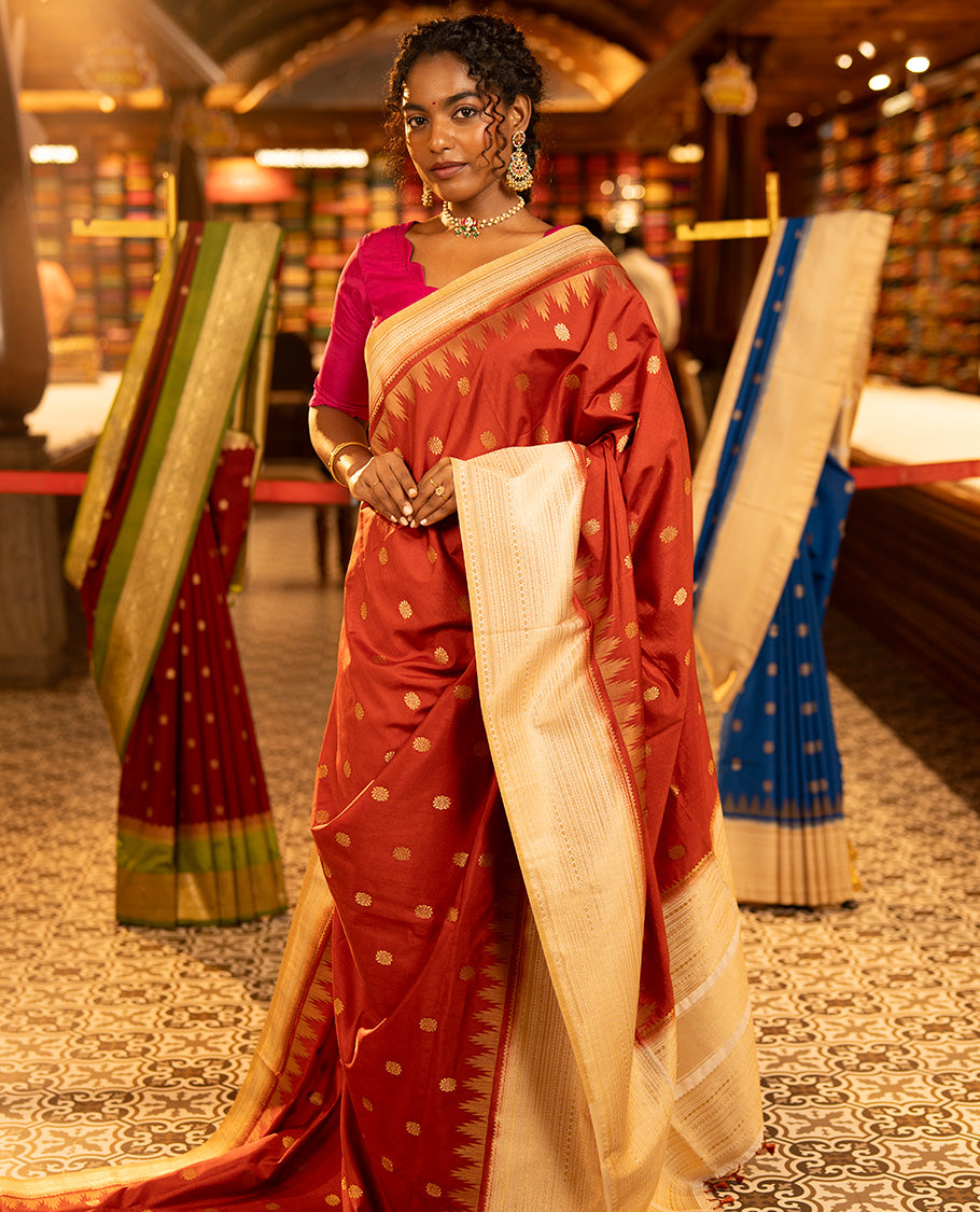 Rust Dupion Silk Saree, Decked Up with Zari Buttas All Over Its Body, Complemented by a Contrast Temple Traditional Zari Design Woven Border, Traditional Pallu of Temple Designs, and Paired with a Contrast Blouse