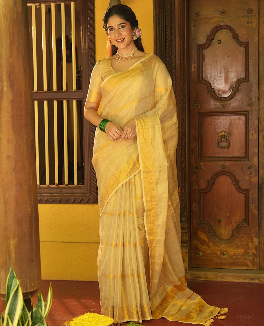 Gleaming Gold Khadi Tissue Saree, Elevated with Zari Stripes All Over Its Body, Highlighted by Zari Bavanji Border, Zari Striped Pallu, and Paired with a Matching Blouse