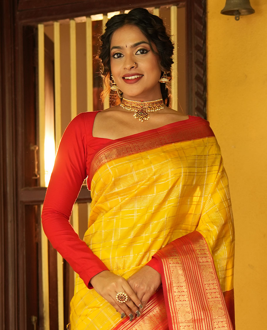 Lemon Yellow and Red Vasundhara Lite Silk Saree, Richly Detailed with Zari Checked Design On Its Body, Complemented by Contrast Varisai Pettu Border of Mayil Chakram Designs, Grand Jaal Pallu, and Paired with a Contrast Blouse