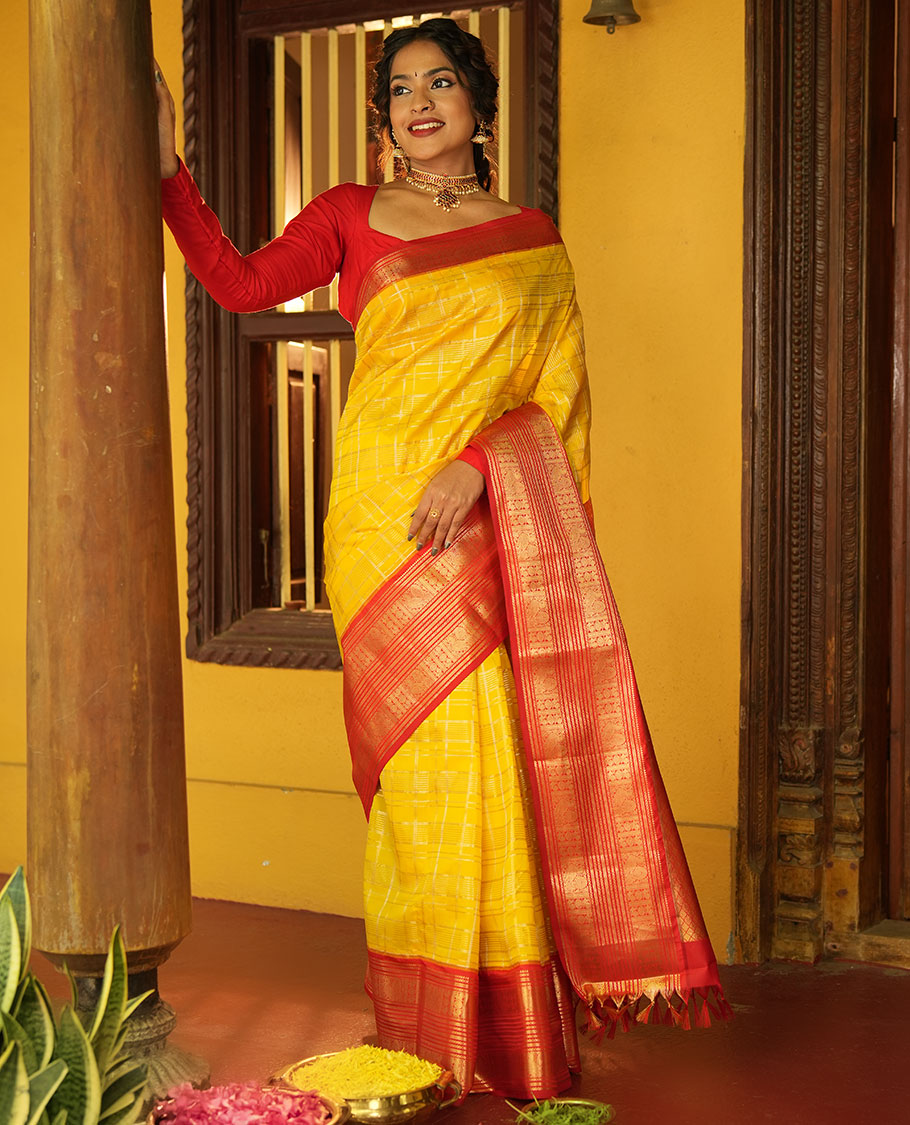 Lemon Yellow and Red Vasundhara Lite Silk Saree, Richly Detailed with Zari Checked Design On Its Body, Complemented by Contrast Varisai Pettu Border of Mayil Chakram Designs, Grand Jaal Pallu, and Paired with a Contrast Blouse