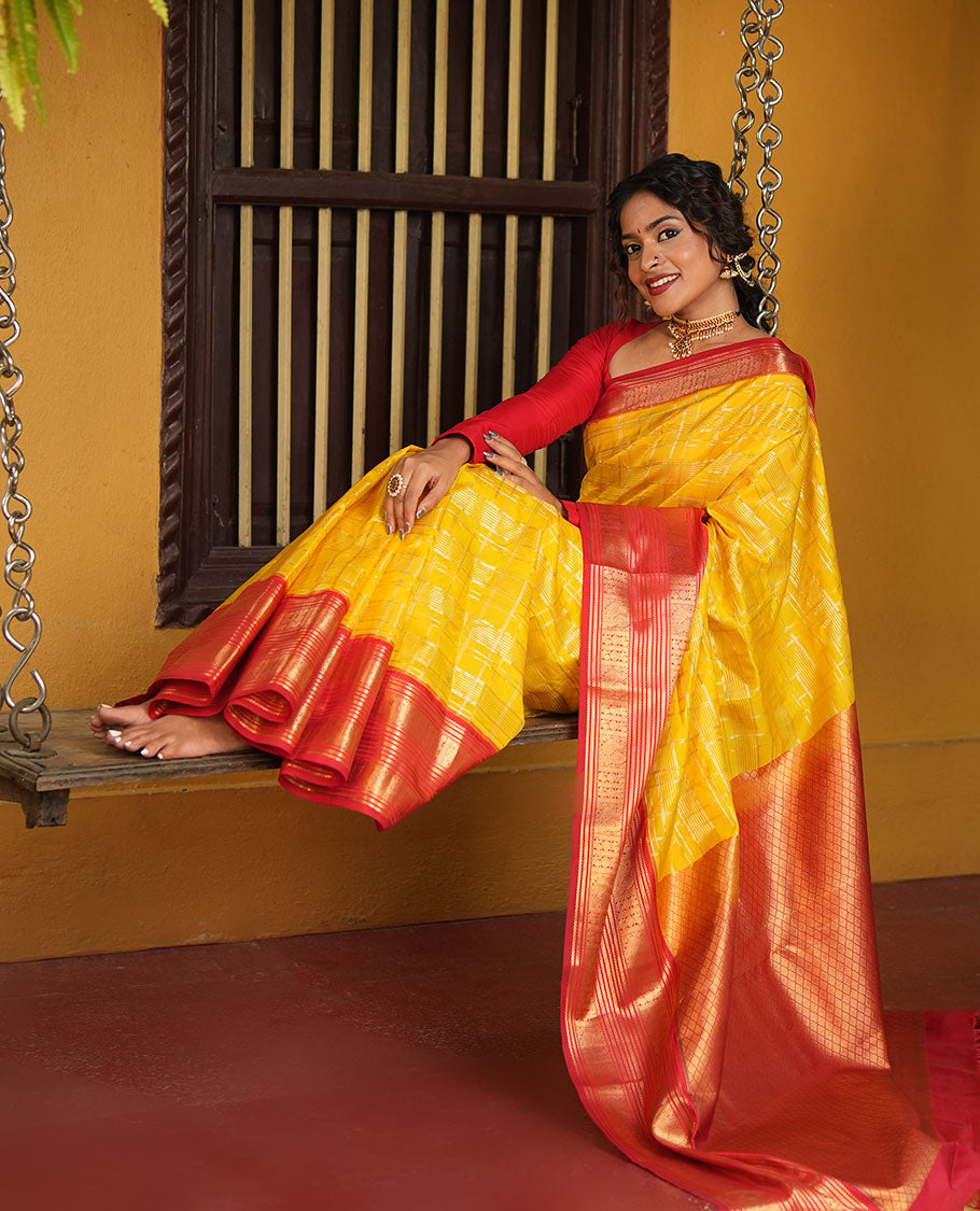 Lemon Yellow and Red Vasundhara Lite Silk Saree, Richly Detailed with Zari Checked Design On Its Body, Complemented by Contrast Varisai Pettu Border of Mayil Chakram Designs, Grand Jaal Pallu, and Paired with a Contrast Blouse