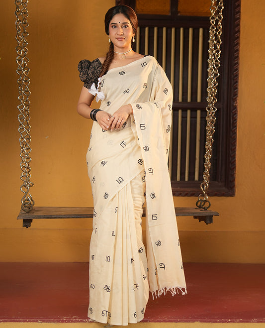 Borderless Cream South Cotton Saree, Elevated with Tamil Letters Printed on Its Body, a Self-Pallu, and Comes with a Matching Blouse, and a Contrast Printed Blouse