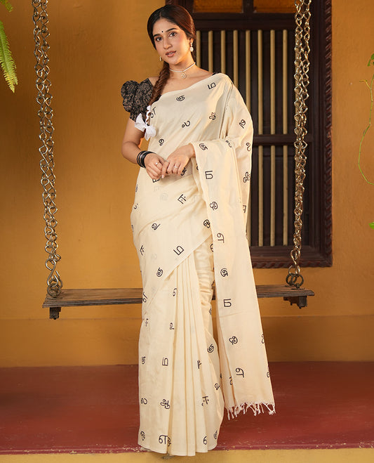 Borderless Cream South Cotton Saree, Elevated with Tamil Letters Printed on Its Body, a Self-Pallu, and Comes with a Matching Blouse, and a Contrast Printed Blouse