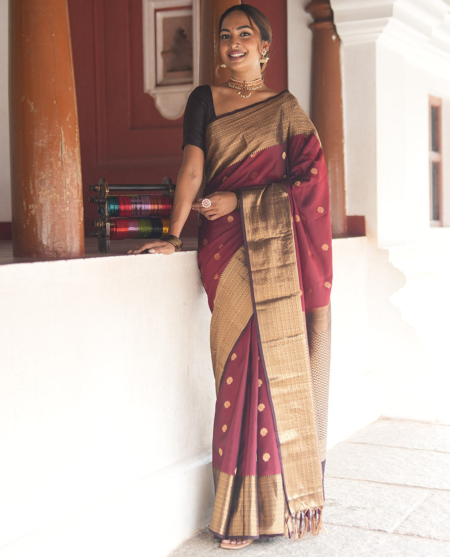 Wine and Maroon Vasundhara Lite Silk Mix Saree, Elevated with Zari Buttas All Over Its Body, Complemented by Contrast Border of Thilakam, Muthu, Banaras, Diamond, Mayil Kann, and Cross Kamalam Designs, Grand Pallu, and Paired with a Contrast Blouse